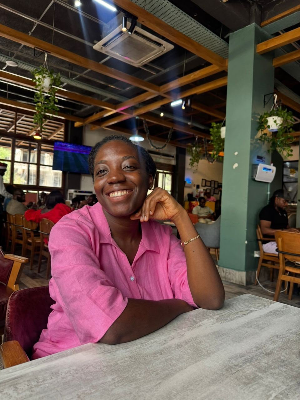 A smiling mum in a pink shirt