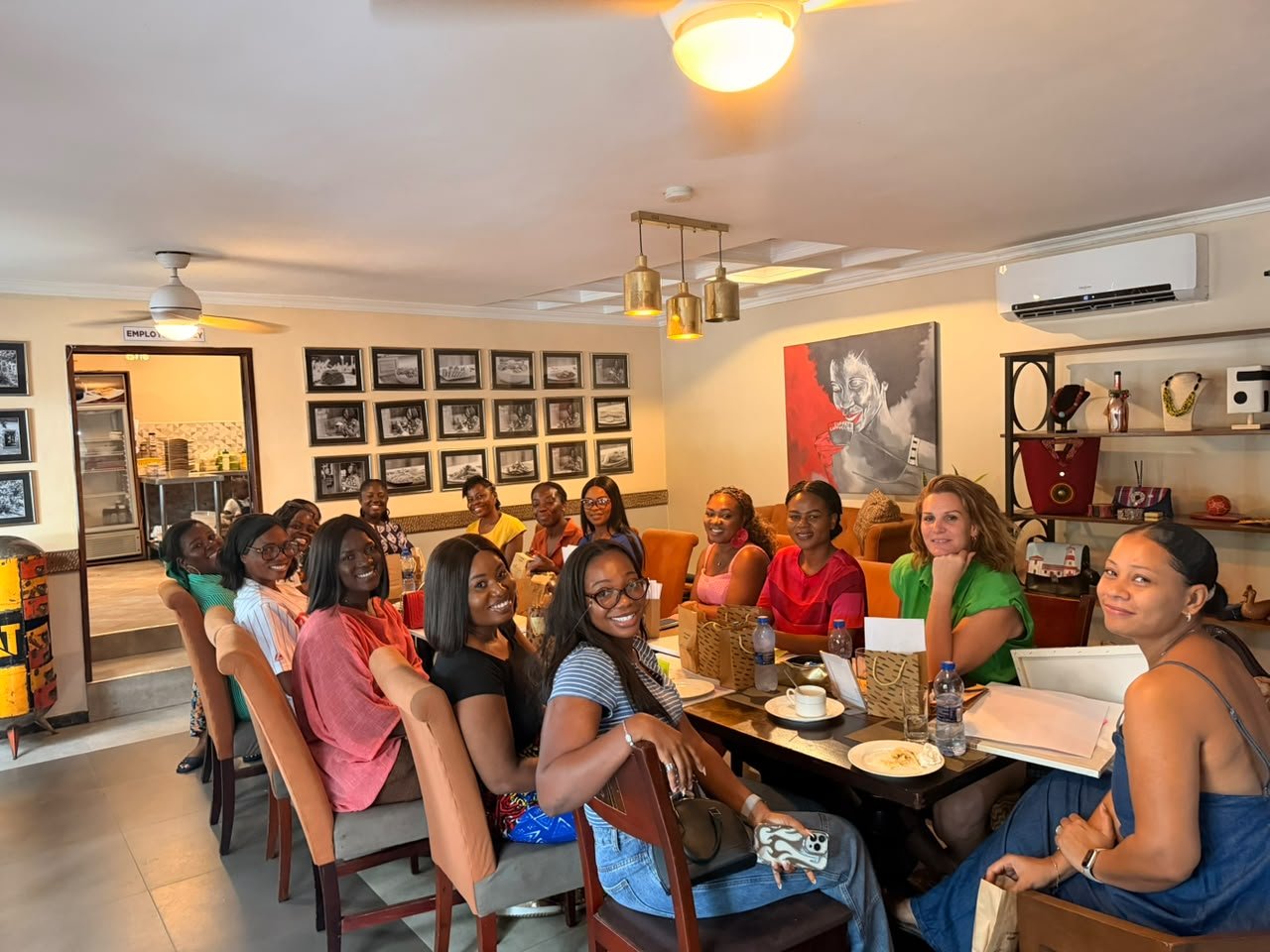 Mums smiling around a long table at a Mum Thrive gathering